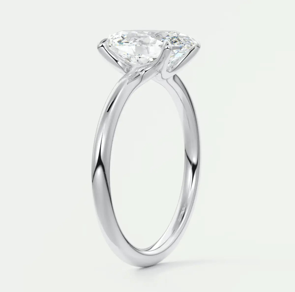 18-karat white gold solitaire engagement ring with a cushion-cut diamond.