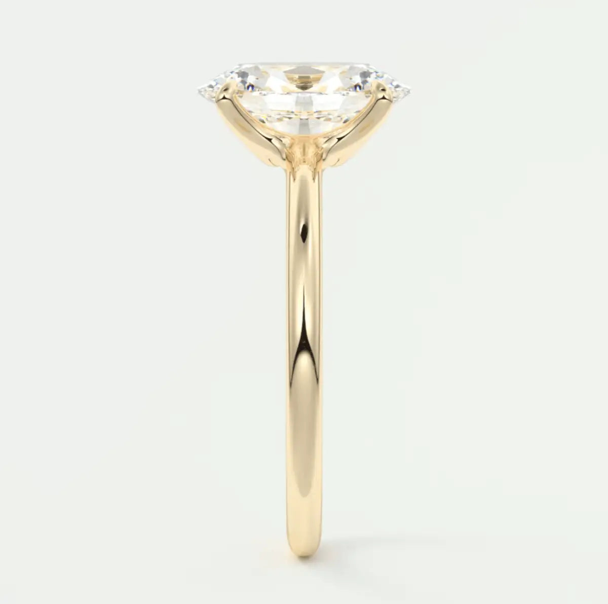 18-karat yellow gold engagement ring with a cushion-cut diamond.