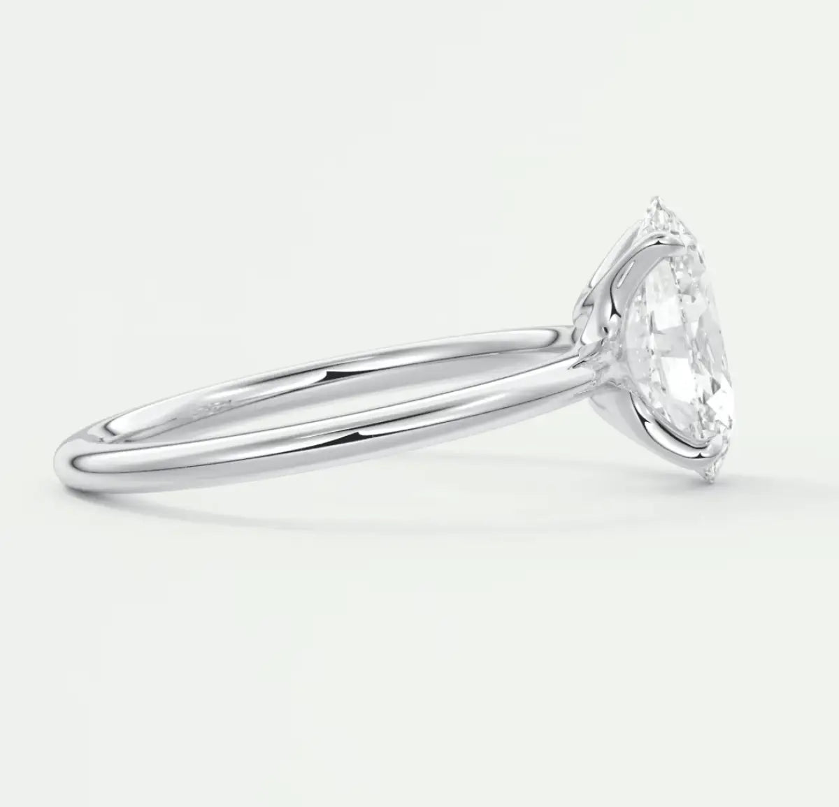 18-karat white gold solitaire engagement ring with a round diamond.