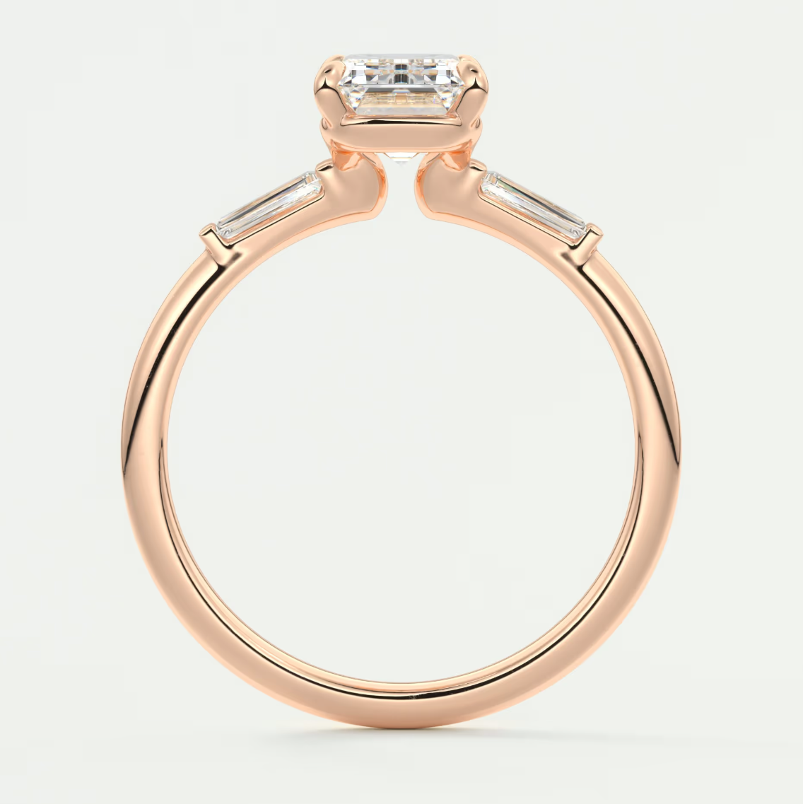 Custom made elysian emerald three-stone engagement ring with tapered baguettes