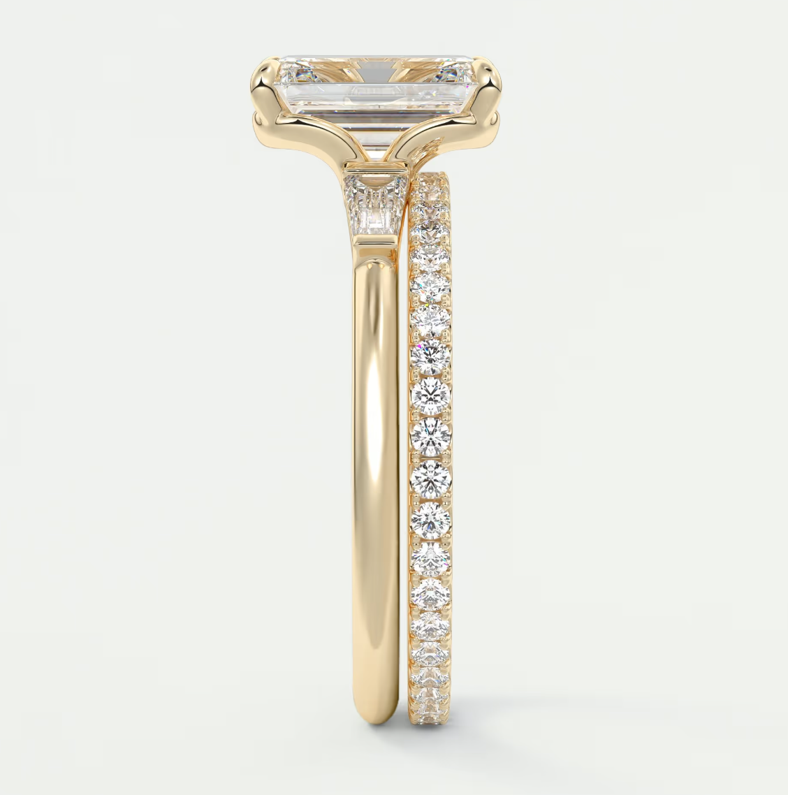 Custom made elysian emerald three-stone engagement ring with tapered baguettes