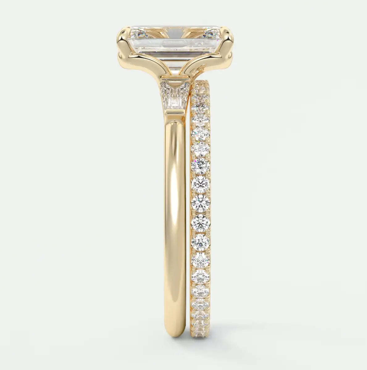 Custom made elysian emerald three-stone engagement ring with tapered baguettes