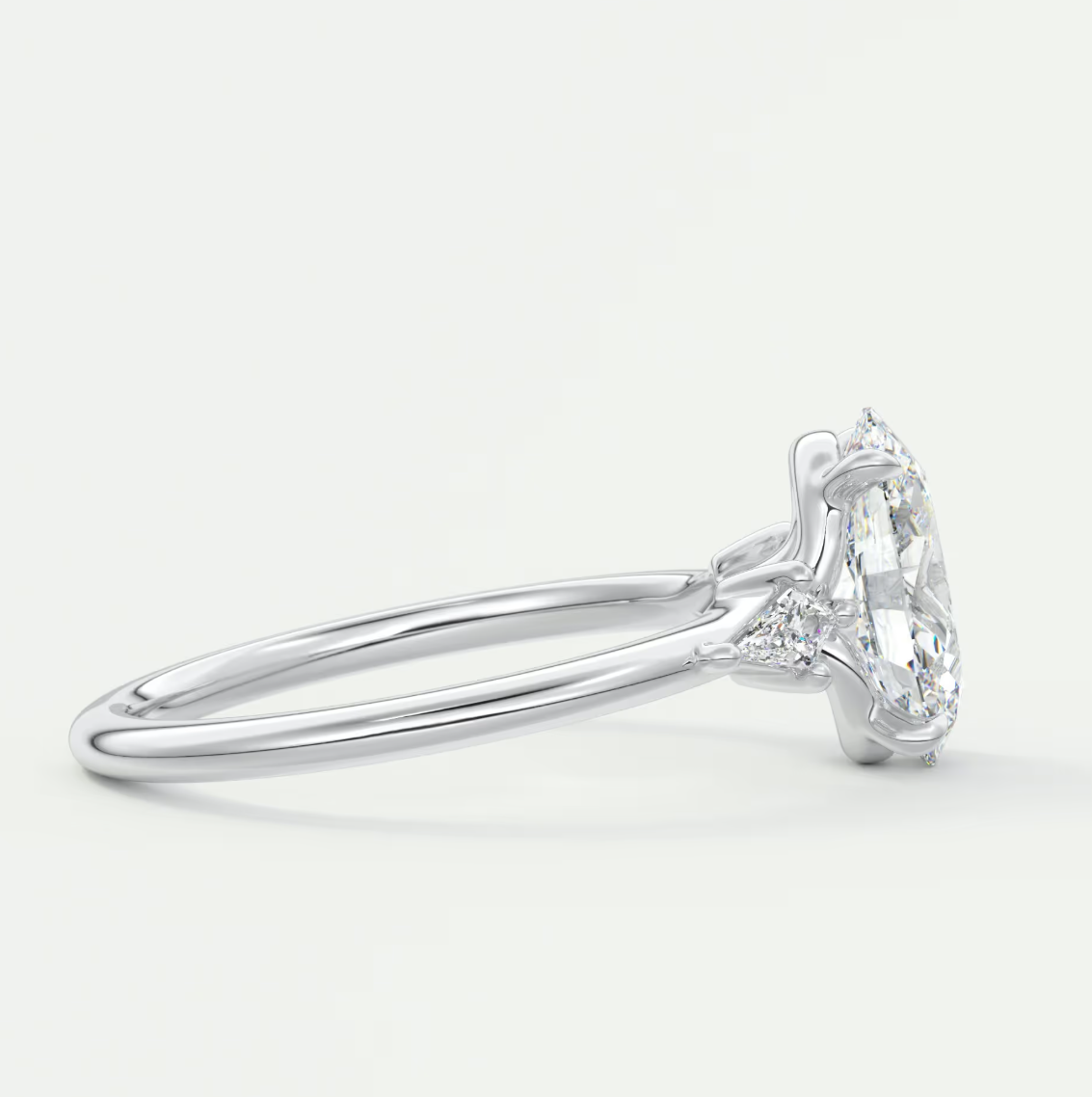 Custom made elysian oval three-stone engagement ring with kite side stones | diamond lab