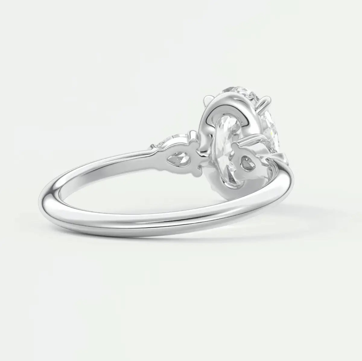 White gold engagement ring with a diamond center stone and floral detailing.