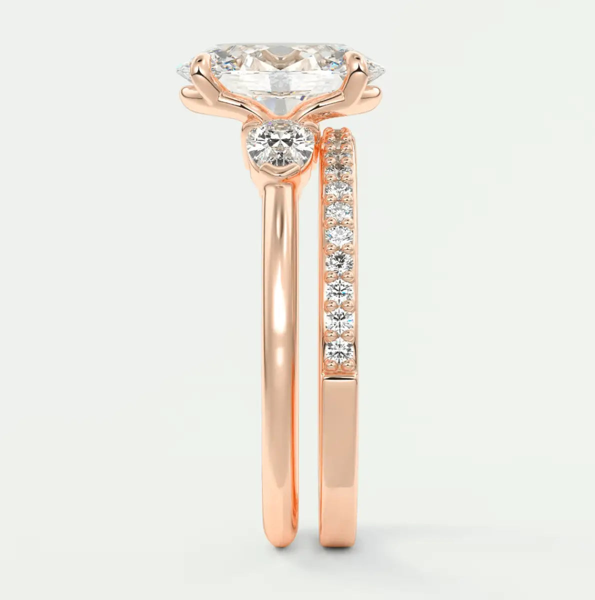 18k rose gold engagement ring with a round diamond center and pavé set diamonds on the band.