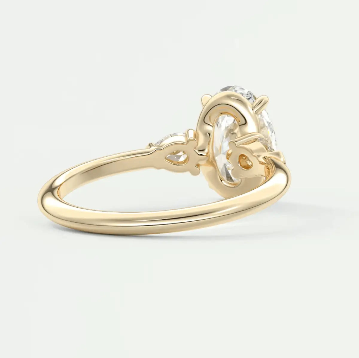 18k yellow gold engagement ring with a round diamond center stone and intricate floral detailing.
