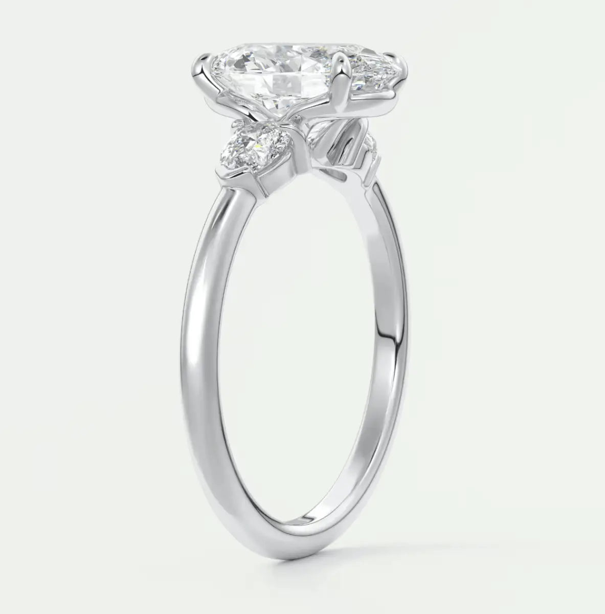 18-karat white gold engagement ring with a round diamond center stone and floral accents.