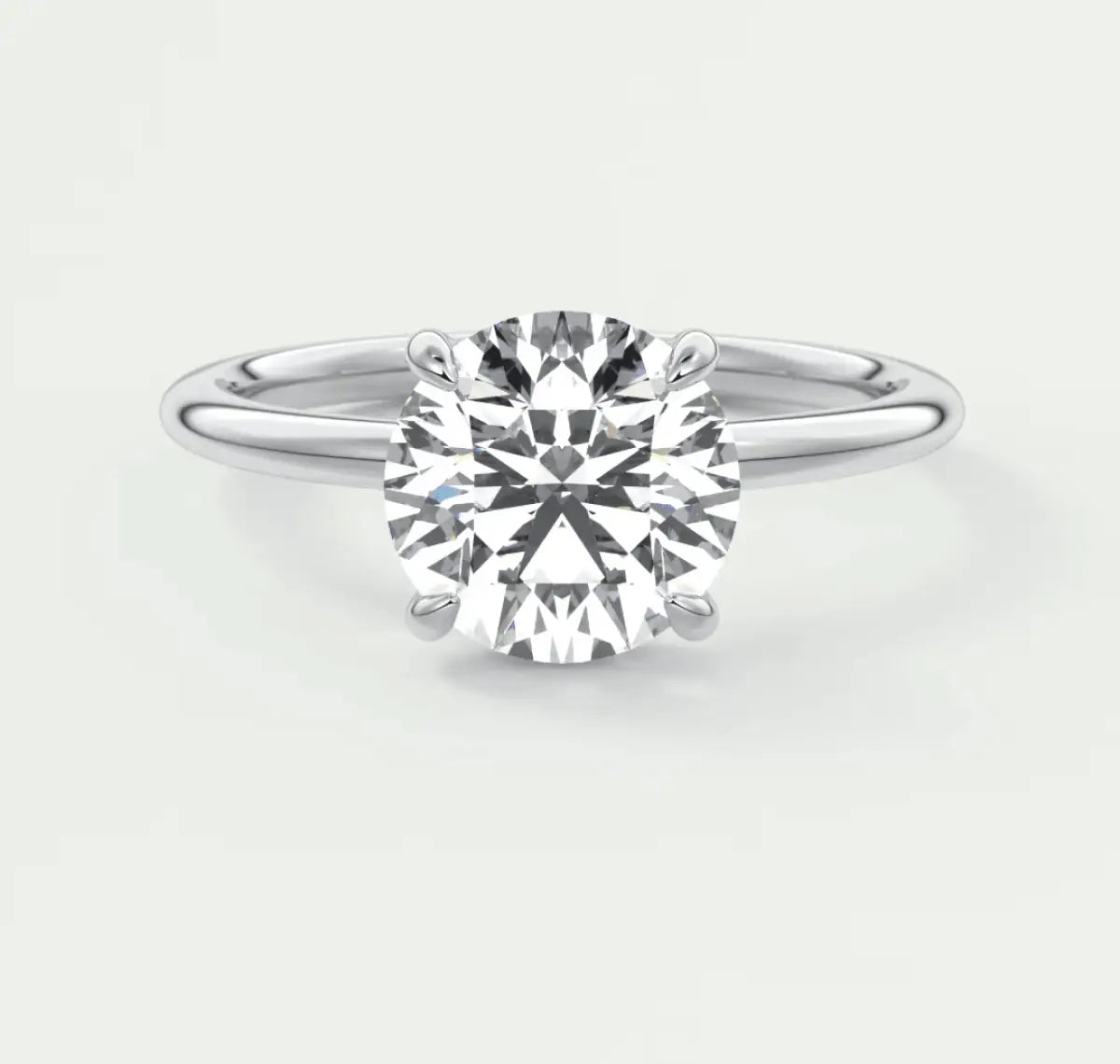 White gold solitaire diamond engagement ring with a round brilliant cut gemstone.