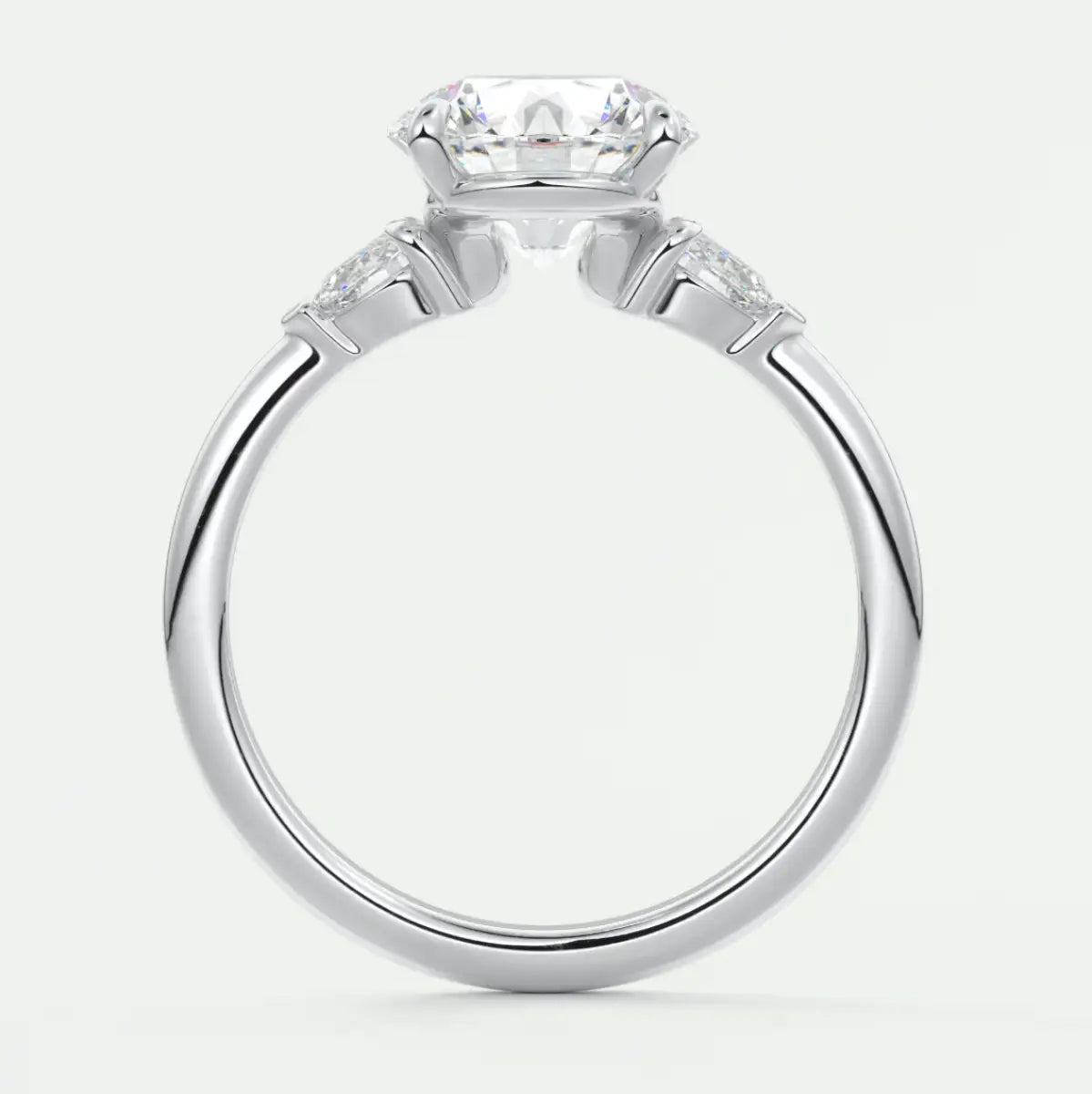 Custom made elysian round three-stone engagement ring with pear side stones | diamond lab