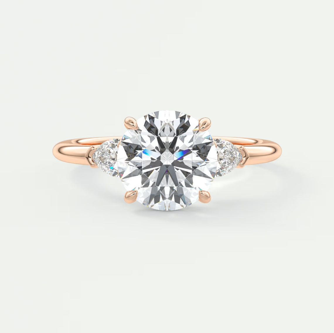 Custom made elysian round three-stone engagement ring with pear side stones | diamond lab