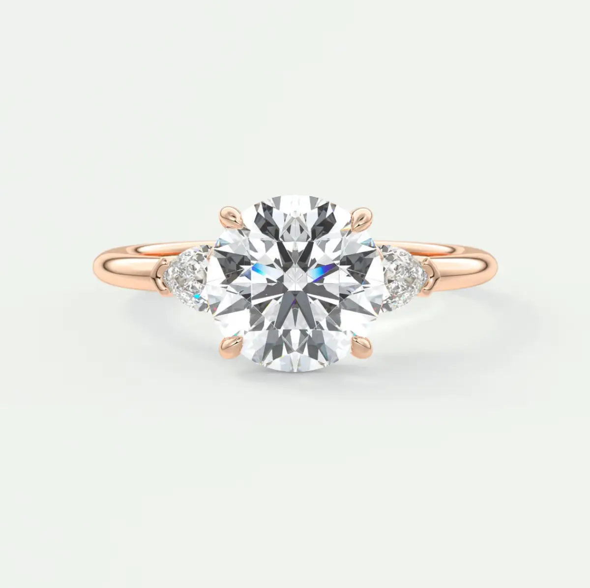 Custom made elysian round three-stone engagement ring with pear side stones | diamond lab