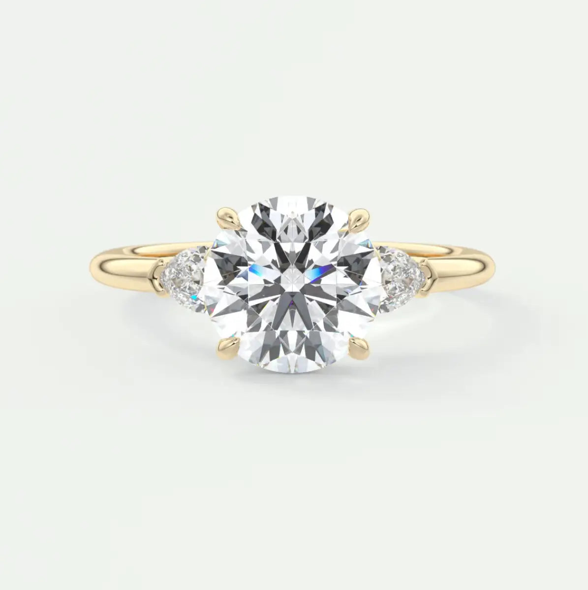 Custom made elysian round three-stone engagement ring with pear side stones | diamond lab