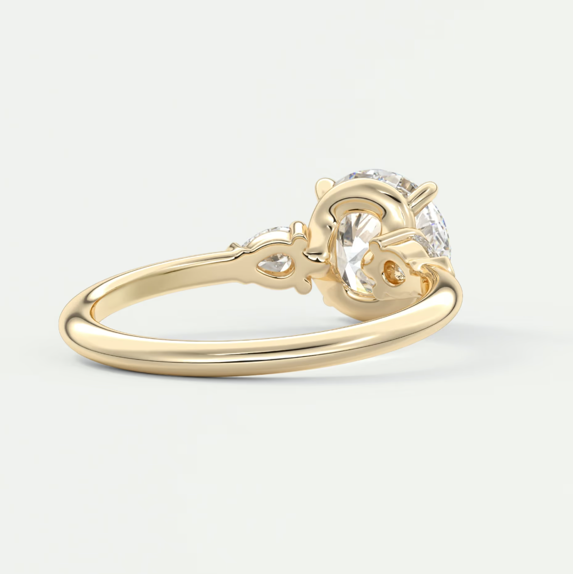 Custom made elysian round three-stone engagement ring with pear side stones | diamond lab