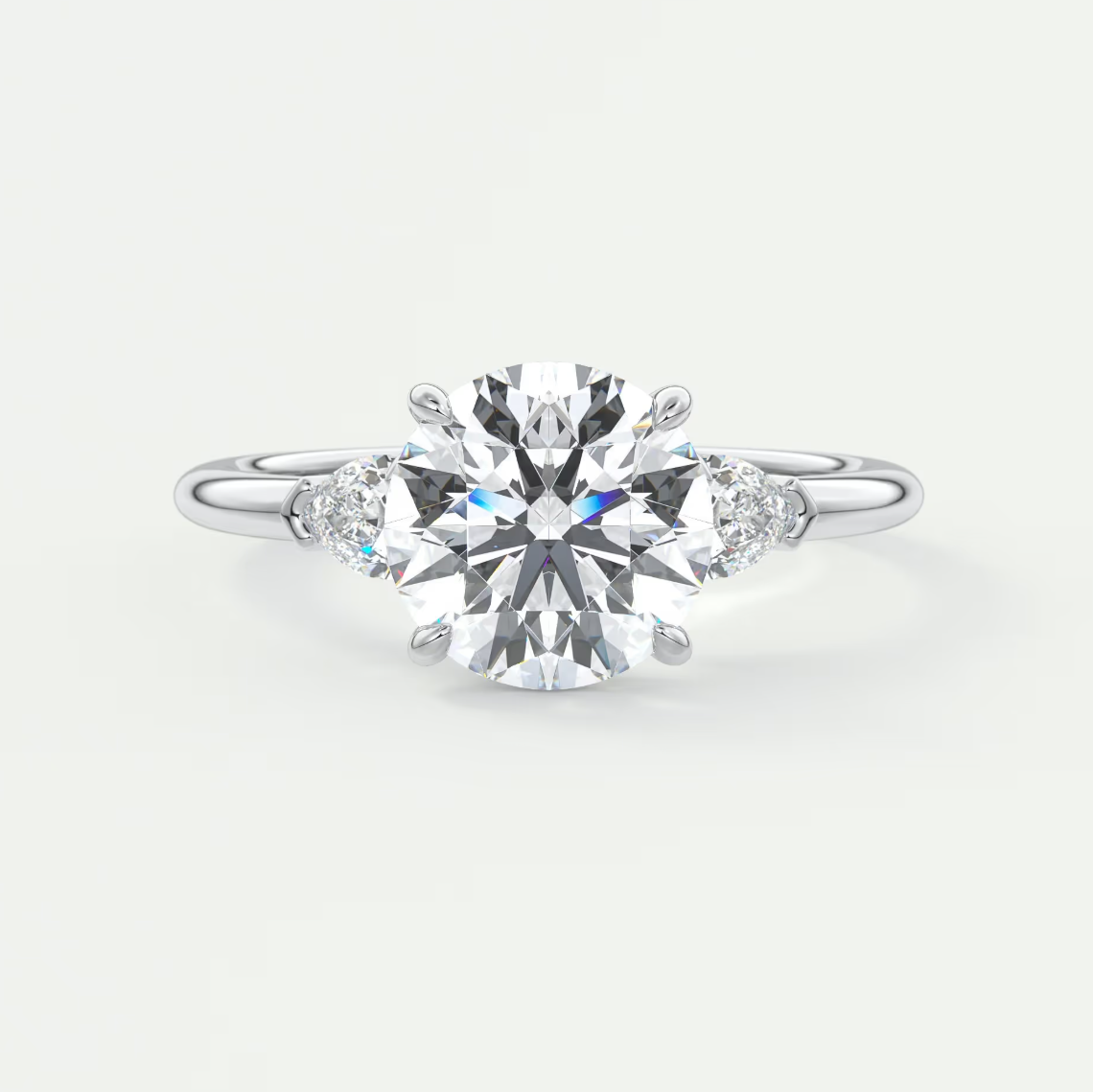 Custom made elysian round three-stone engagement ring with pear side stones | diamond lab