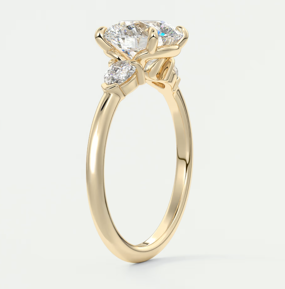Custom made elysian round three-stone engagement ring with pear side stones | diamond lab