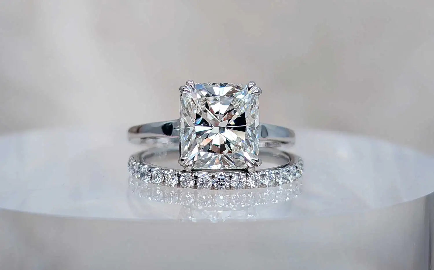 Diamond ring with a square-cut gemstone on a white surface