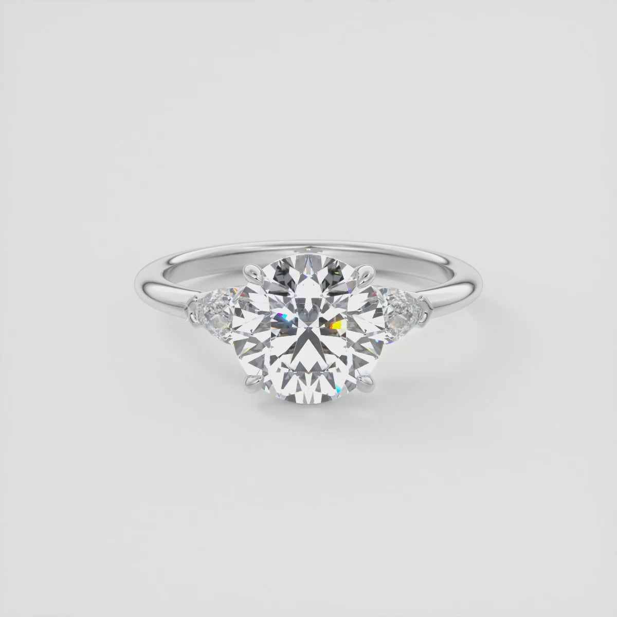 Elysian Round Three-Stone Engagement Ring with Pear Side Stones