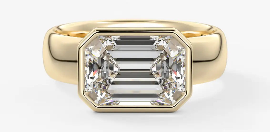 Gold ring with a large diamond on a white background