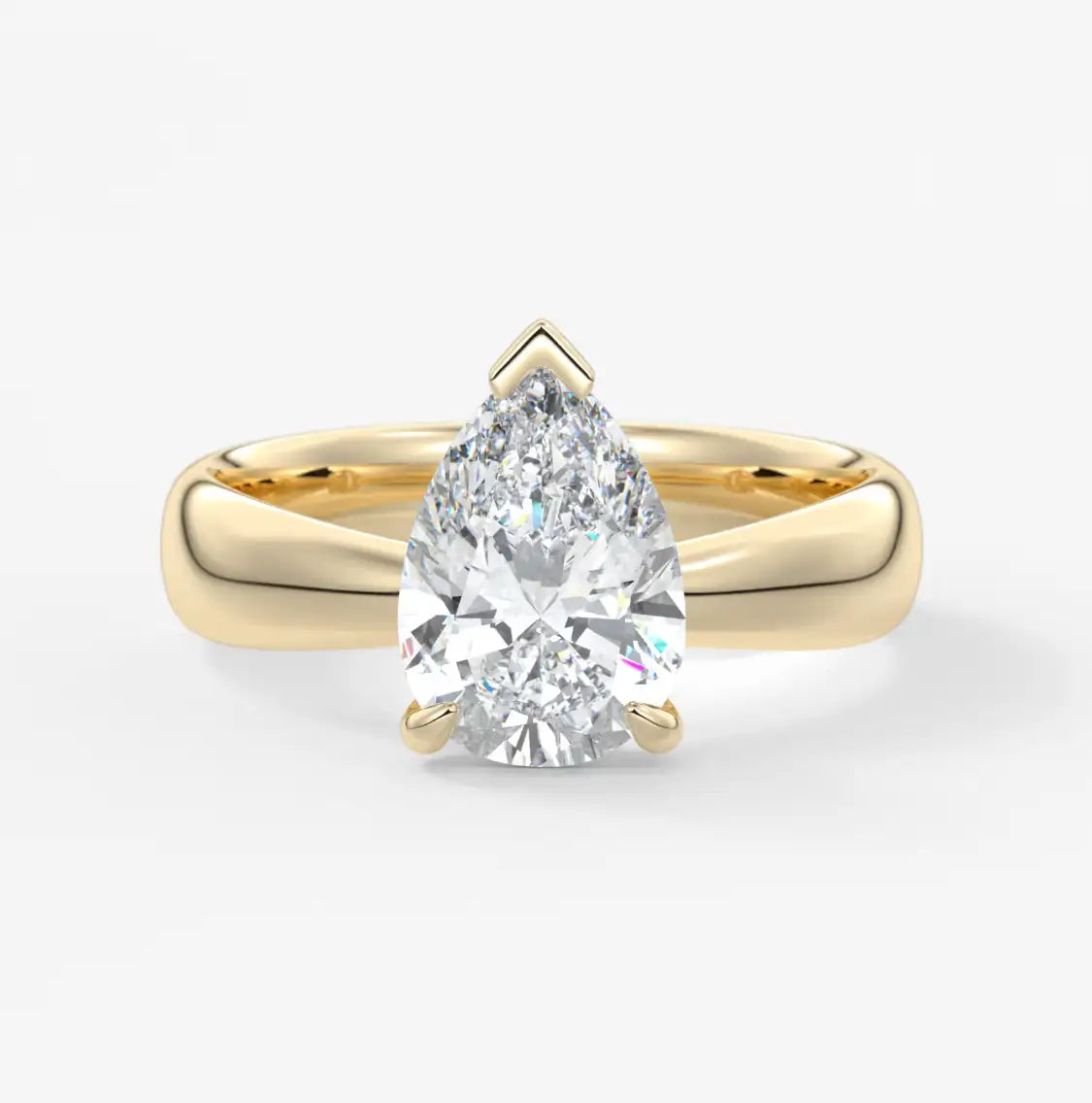 A radiant pear-shaped diamond set in a sleek, 18k yellow gold band with elegant prongs.
