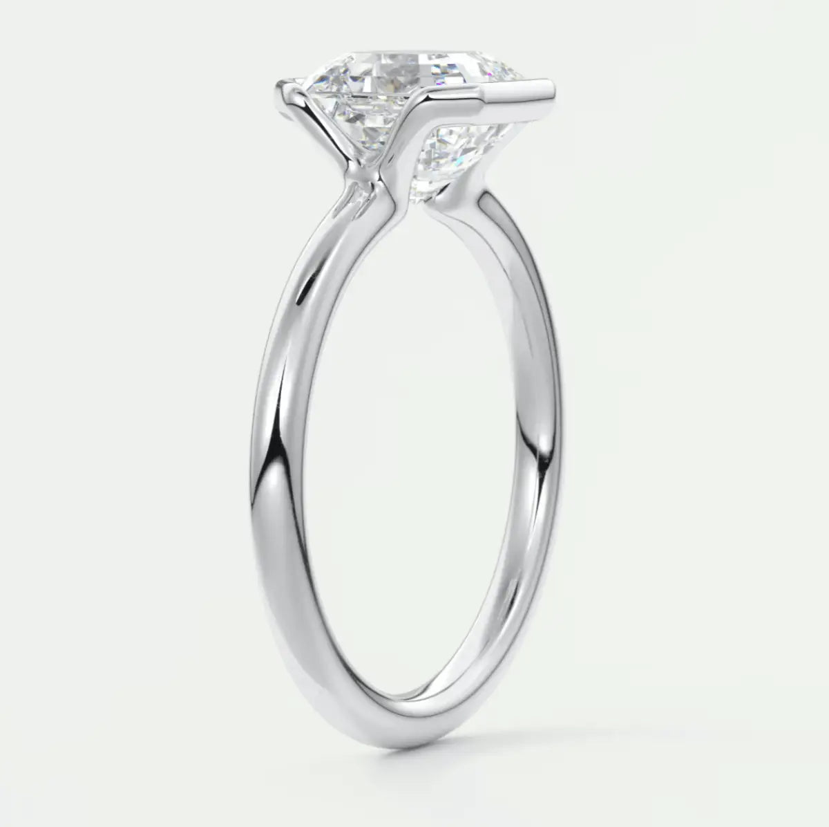 18-karat white gold solitaire engagement ring with a princess-cut diamond.