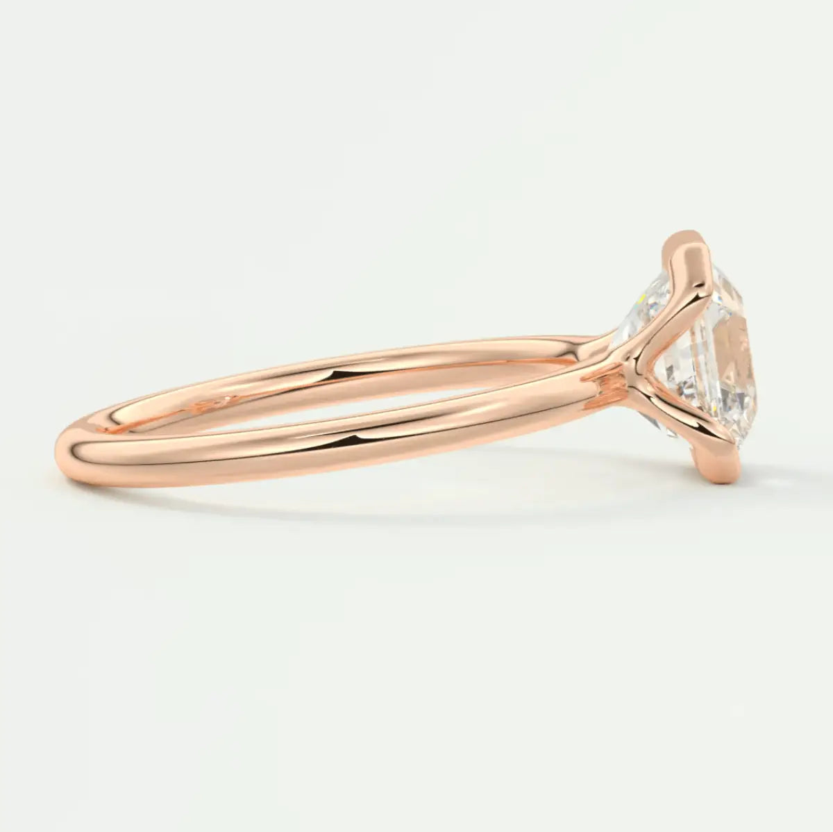 18k rose gold engagement ring with a marquise-cut diamond.