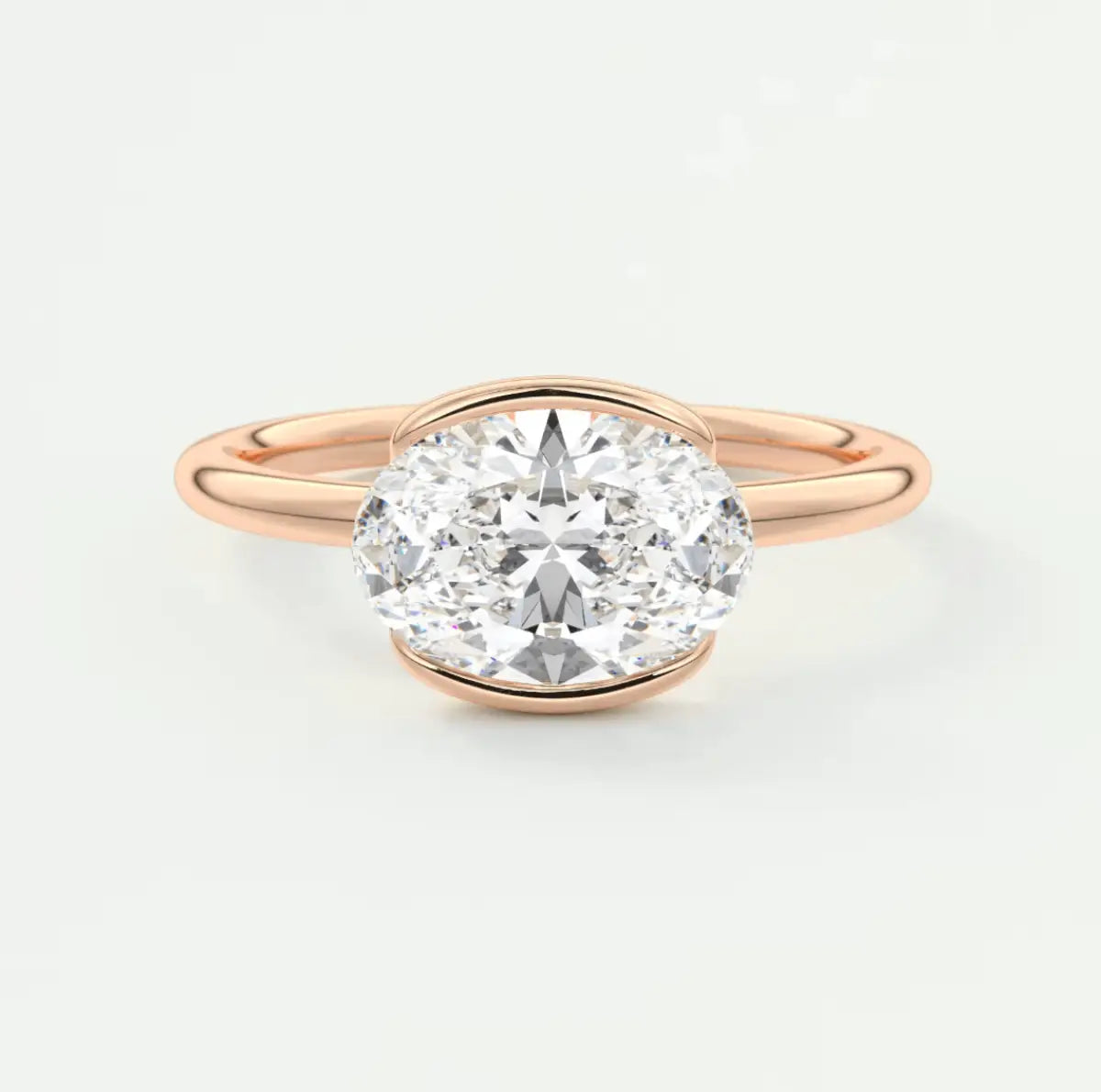 Rose gold oval diamond engagement ring with a solitaire design.