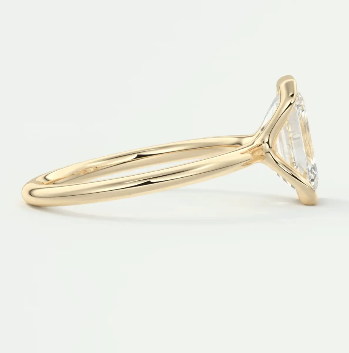 18k yellow gold engagement ring with a marquise-cut diamond.