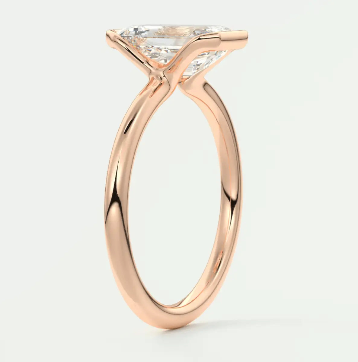 Rose gold princess cut diamond engagement ring with a twisted band design.