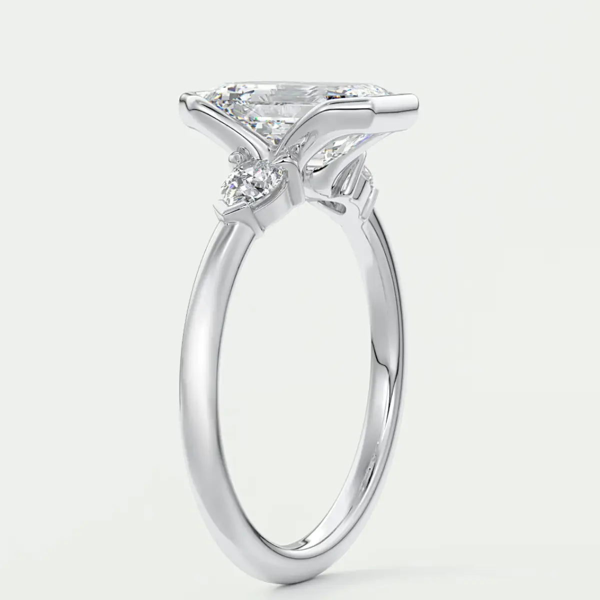 Custom made solara emerald half bezel three-stone engagement ring | diamond lab