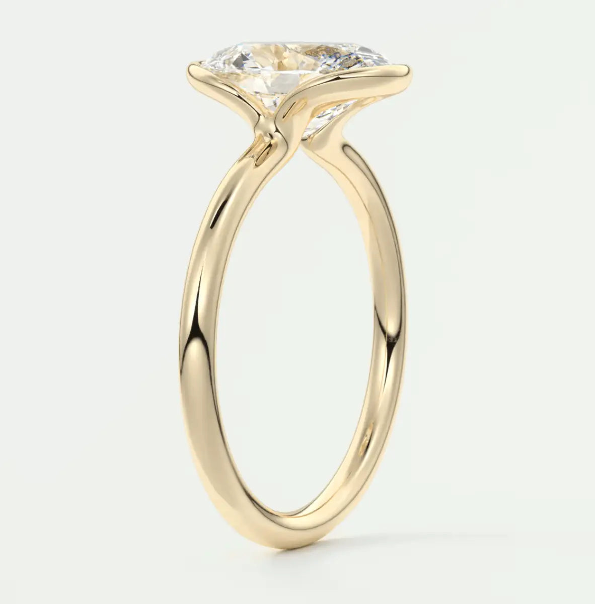 18-karat yellow gold engagement ring with a large, round diamond.