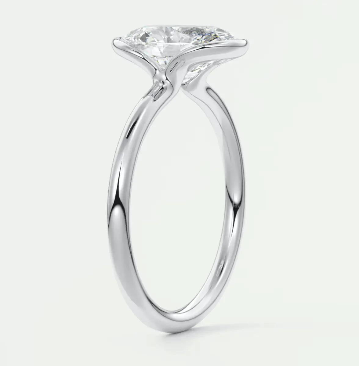 18k white gold solitaire diamond engagement ring with a round brilliant cut stone.