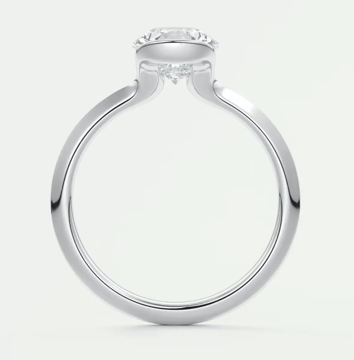 White gold engagement ring with a round diamond center stone and delicate floral accents.