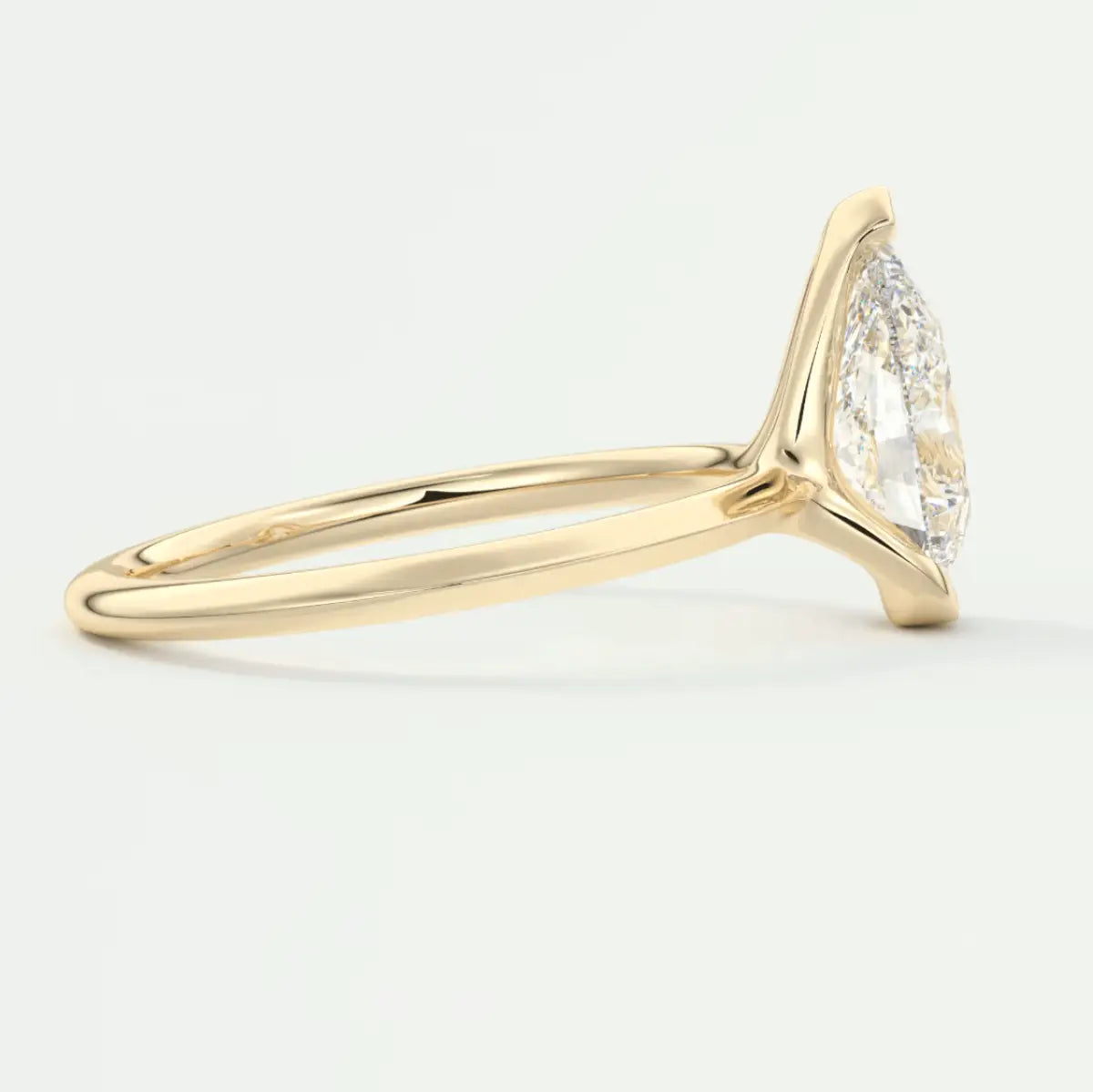 18k yellow gold marquise diamond engagement ring with a halo of smaller diamonds.