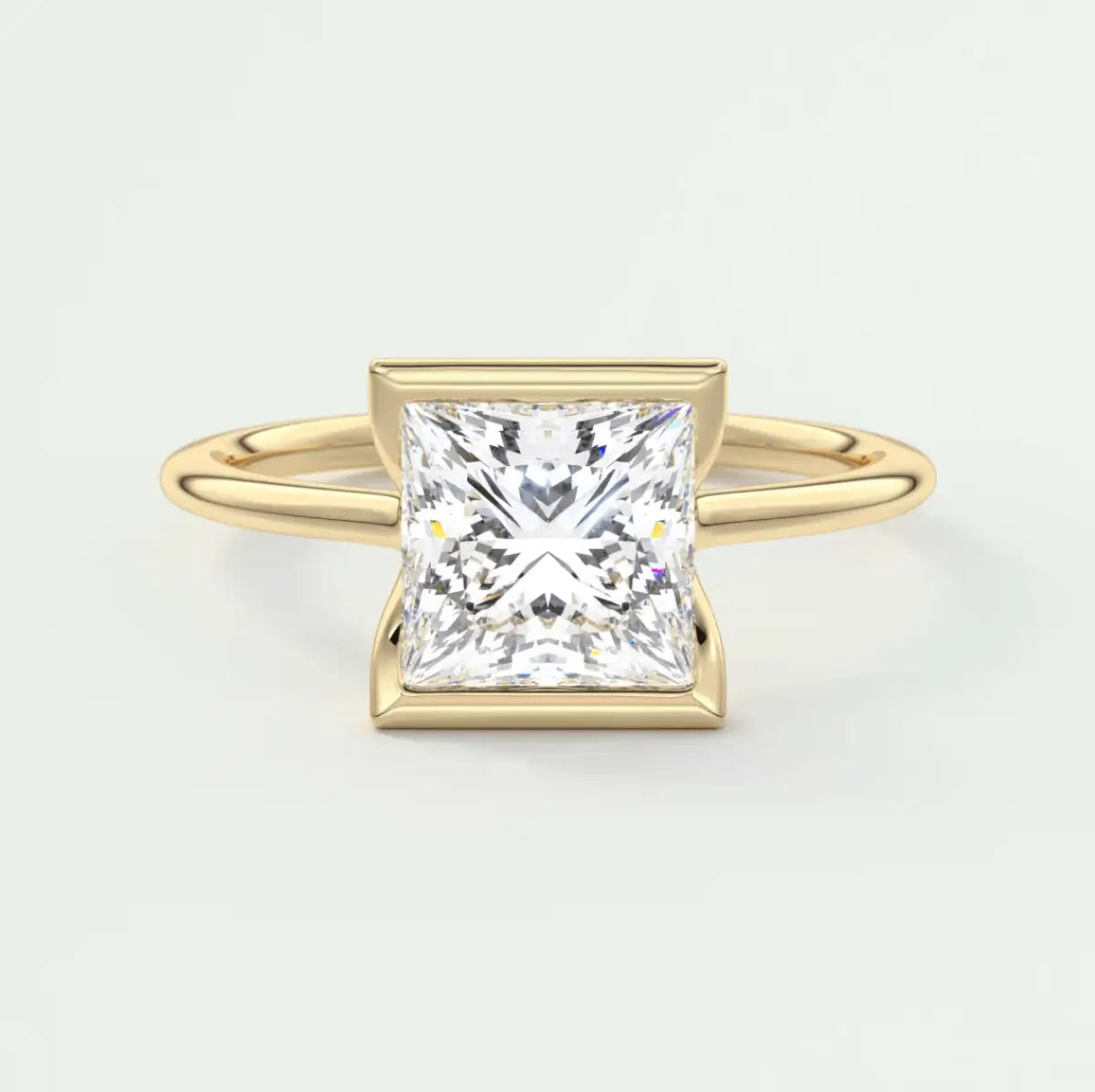 Princess cut diamond engagement ring in yellow gold with a square bezel setting.