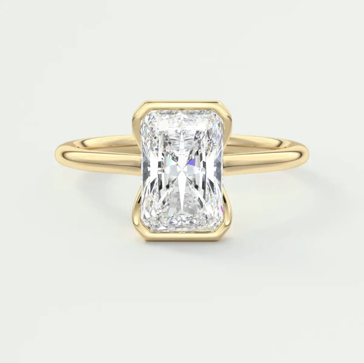 18k yellow gold engagement ring with a radiant cut diamond.