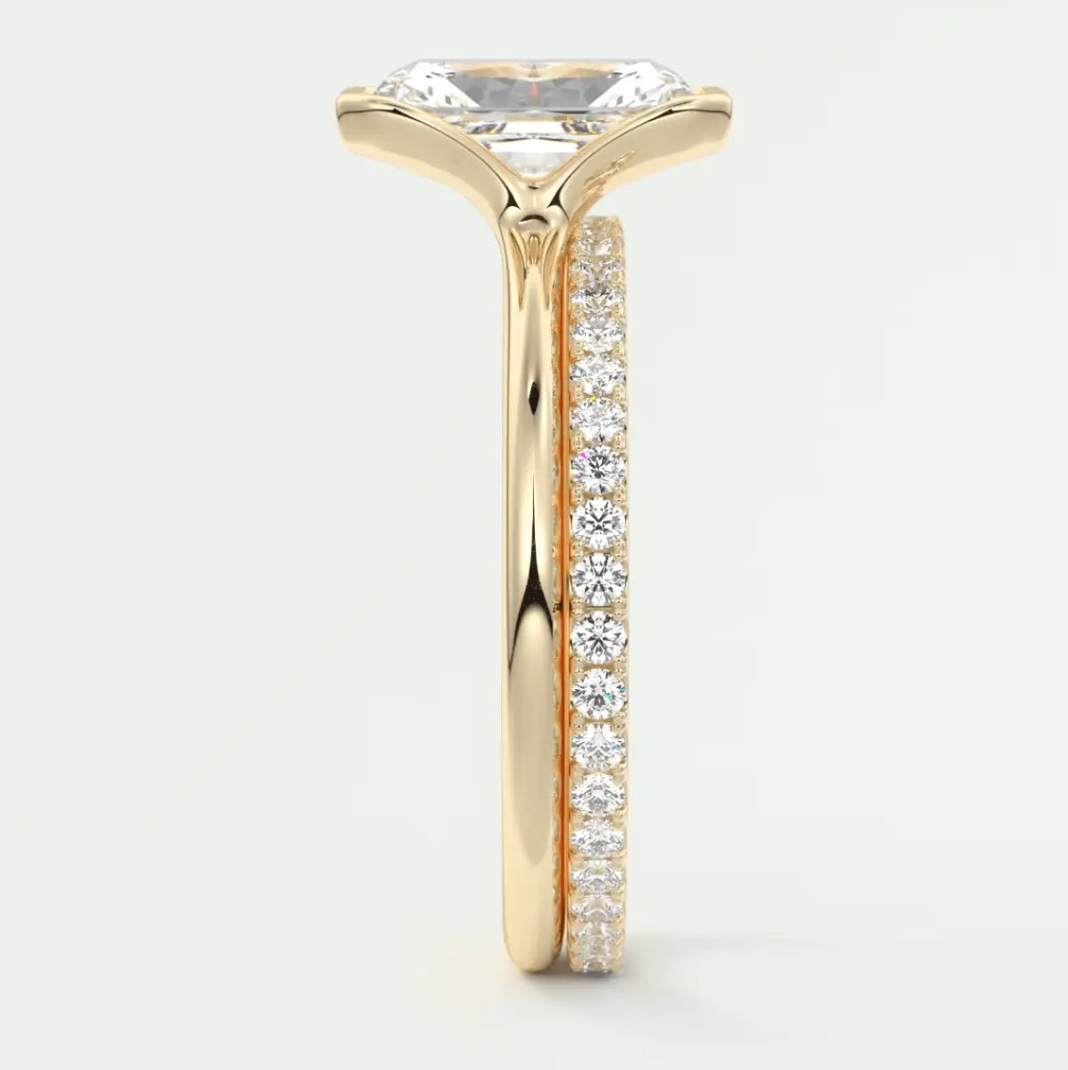 18k yellow gold engagement ring with princess cut diamond and pave set diamonds on the band.