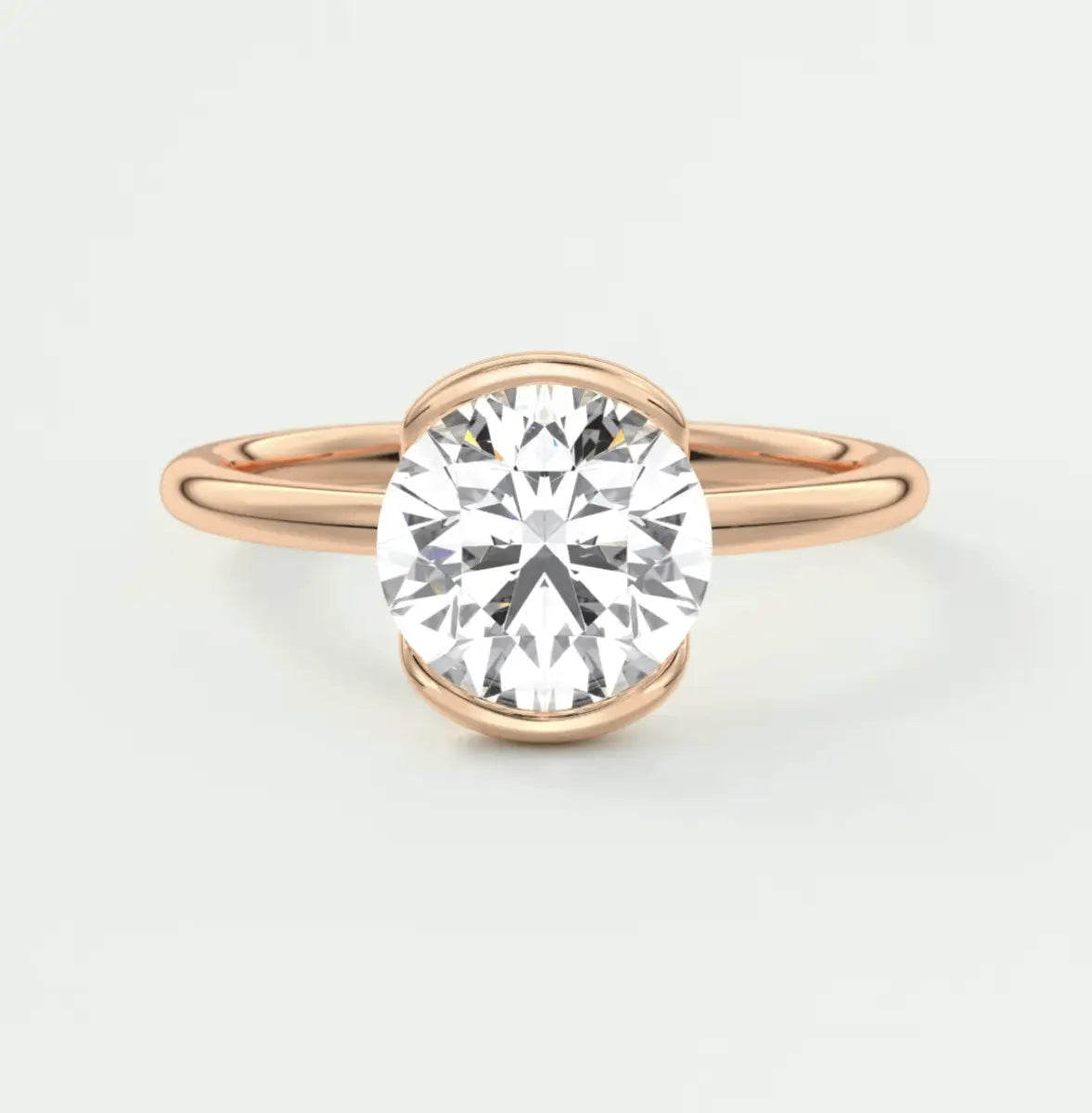 18-karat rose gold diamond engagement ring with a round-cut center stone.