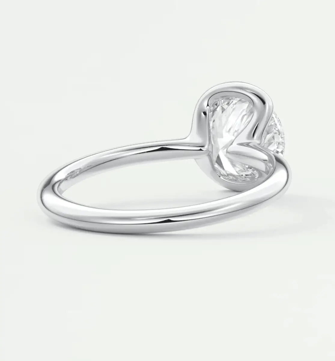 Pear-shaped diamond engagement ring with a heart-shaped band, silver