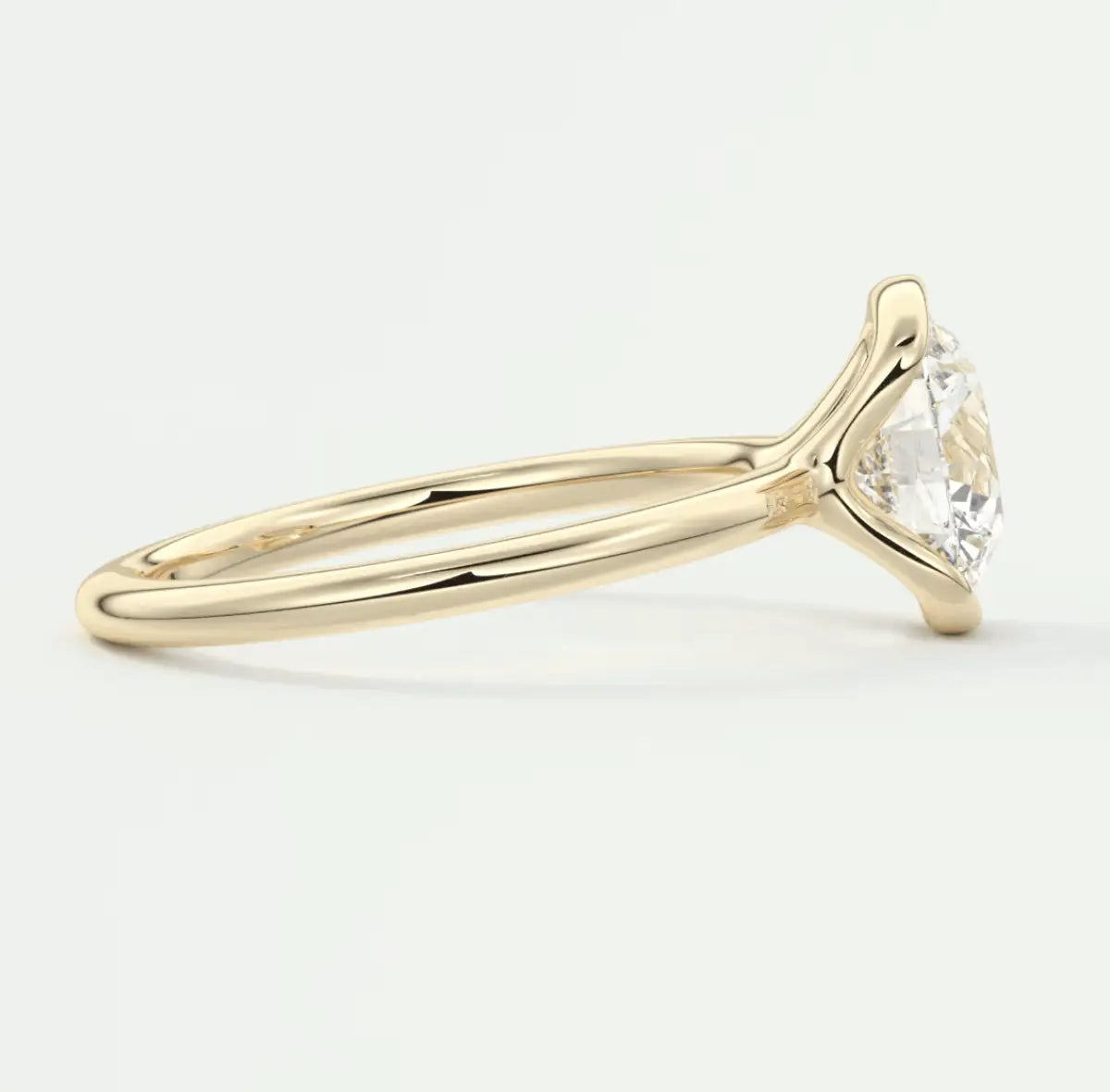 18k yellow gold solitaire engagement ring with a round diamond.