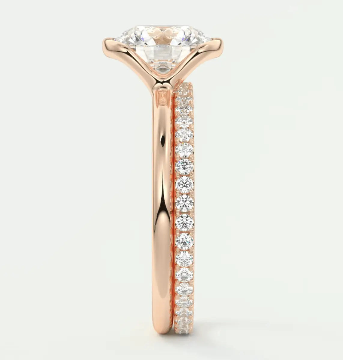 18k rose gold diamond engagement ring with a round brilliant cut center stone and pave set diamonds on the band.