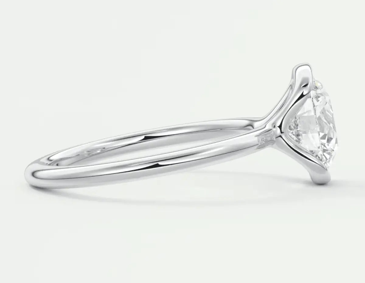 Pear-shaped diamond engagement ring with a white gold band.