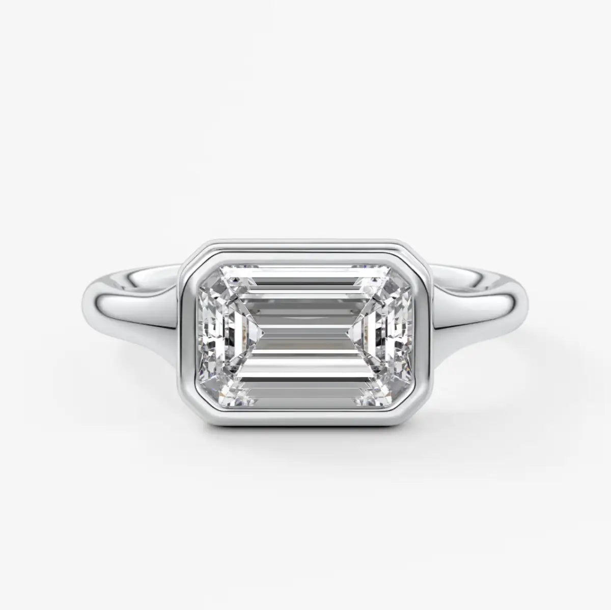18k white gold emerald cut diamond engagement ring with baguette side stones.