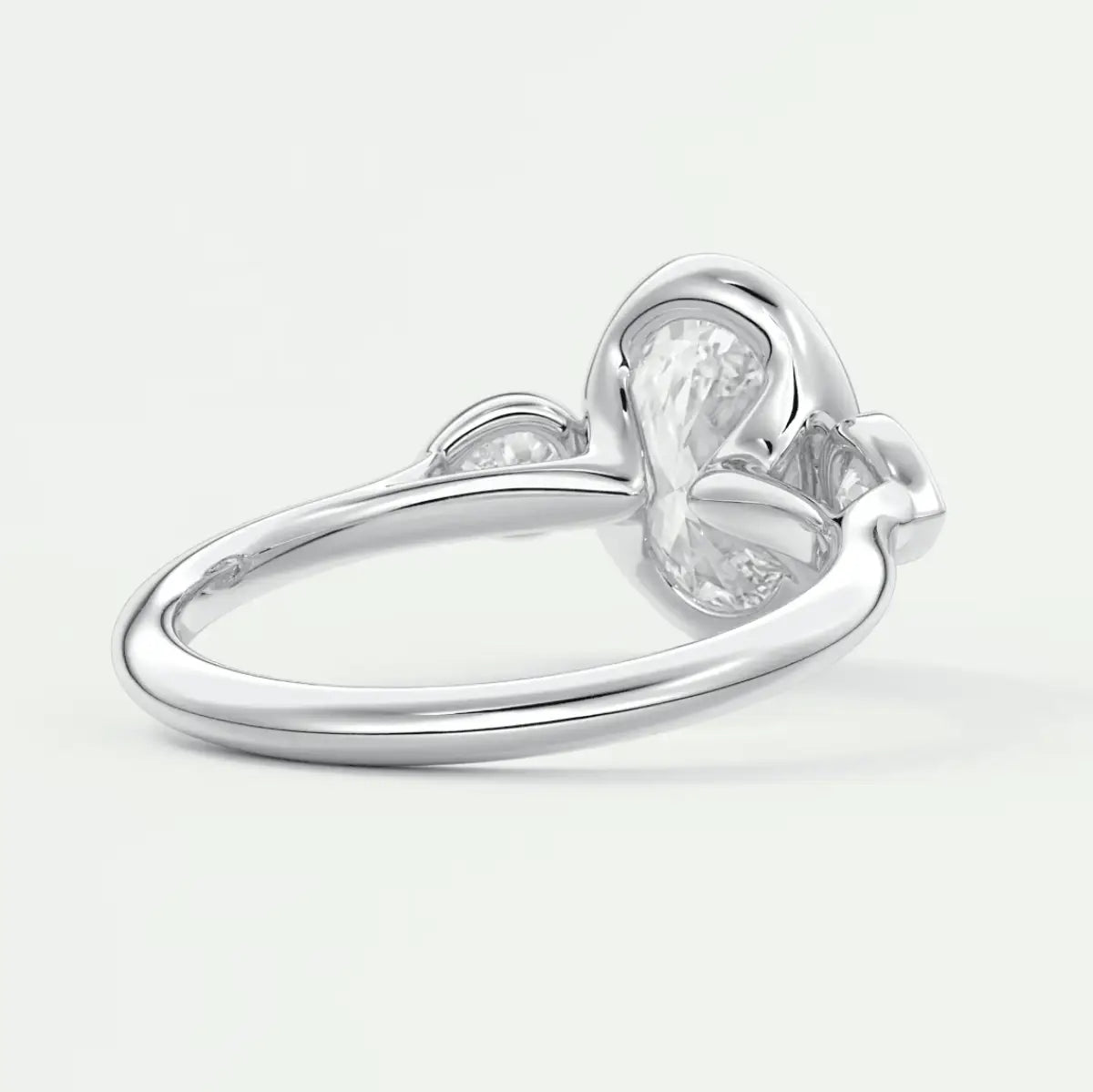 White gold heart-shaped diamond engagement ring with a pear-cut center stone and small diamonds on the band.