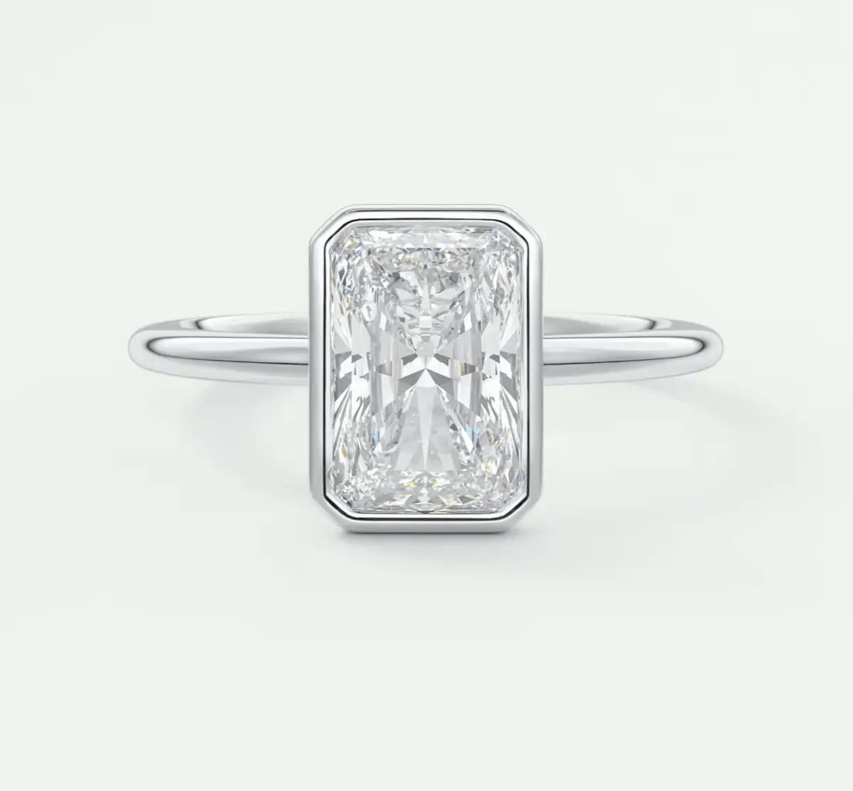 18-karat white gold engagement ring with an emerald-cut diamond.