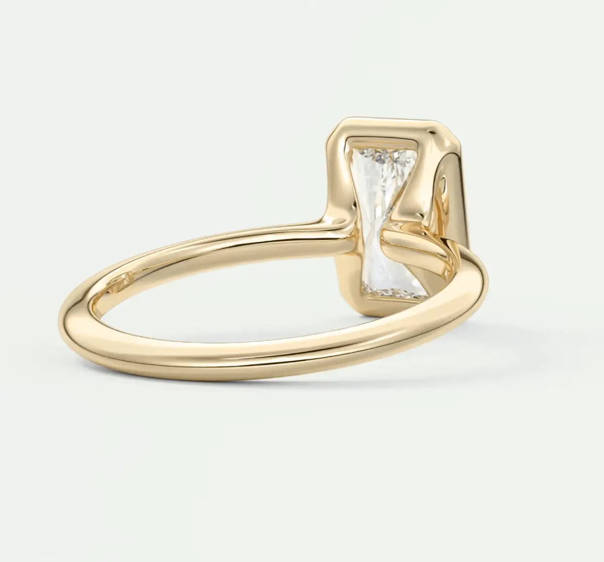 18k yellow gold engagement ring with a baguette diamond and small accent diamonds.