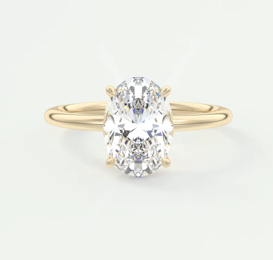 18k yellow gold oval diamond engagement ring with a solitaire design.