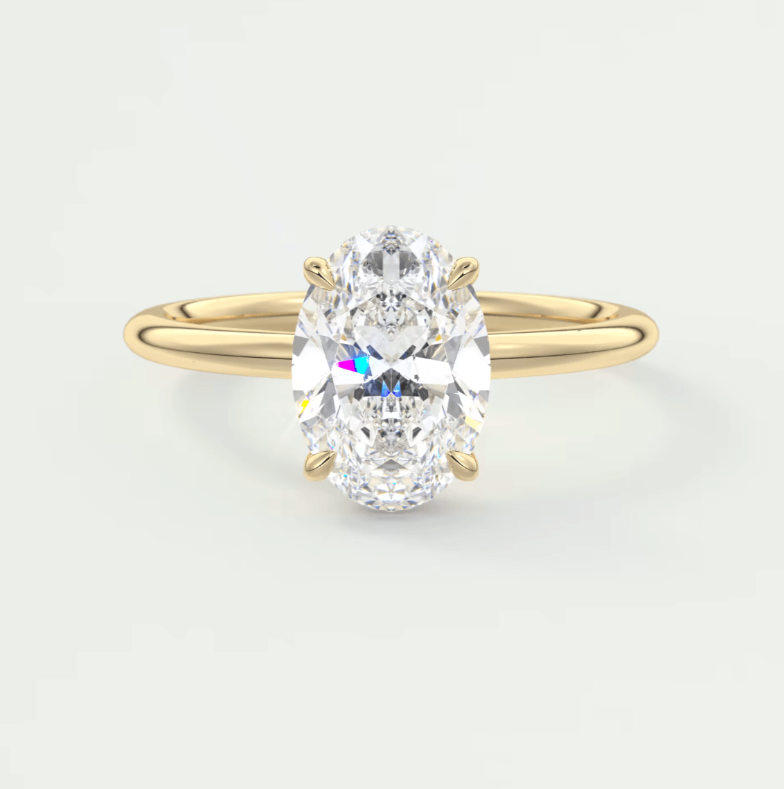 18k yellow gold oval diamond engagement ring with a solitaire design.