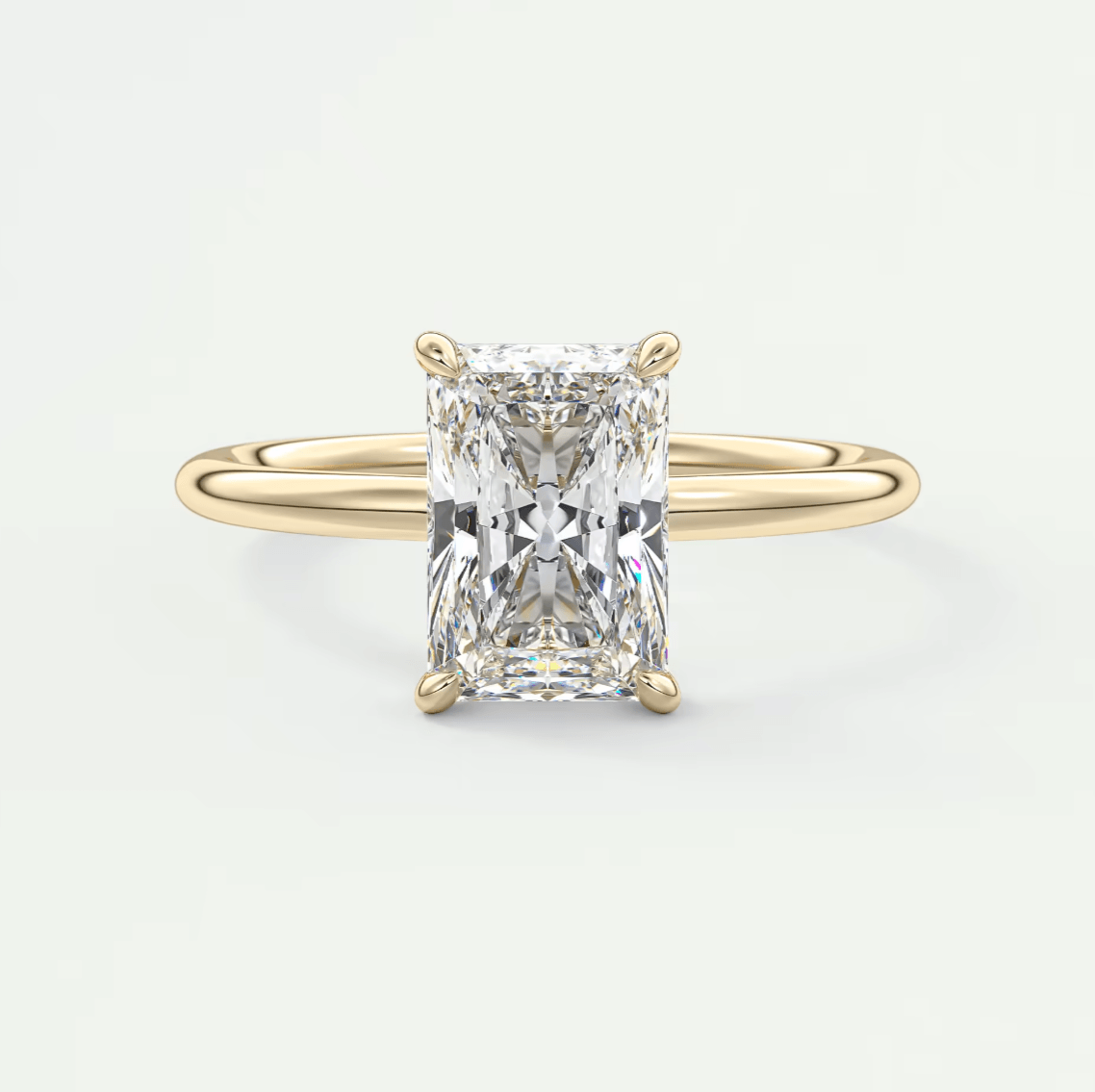 18k yellow gold engagement ring with a radiant cut diamond.