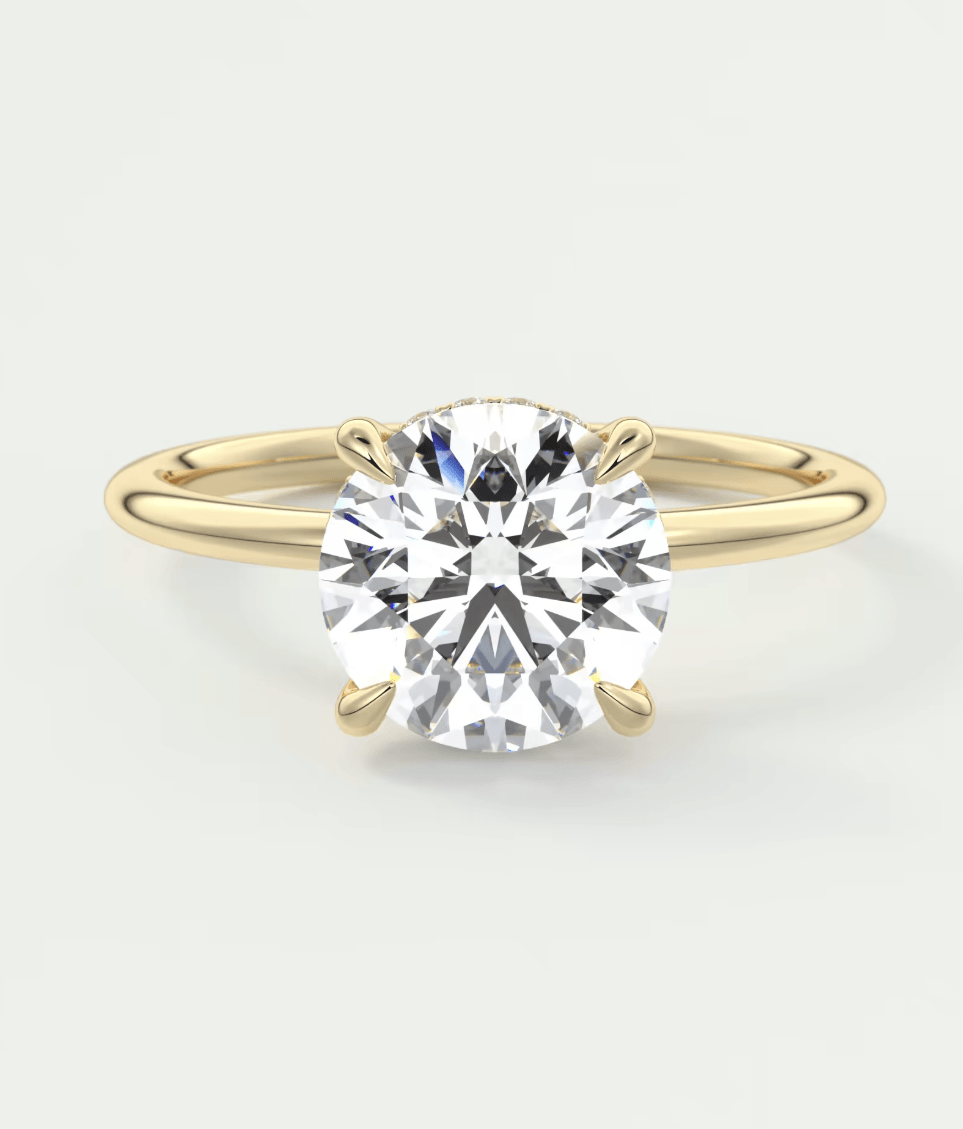 18-karat yellow gold solitaire diamond engagement ring.