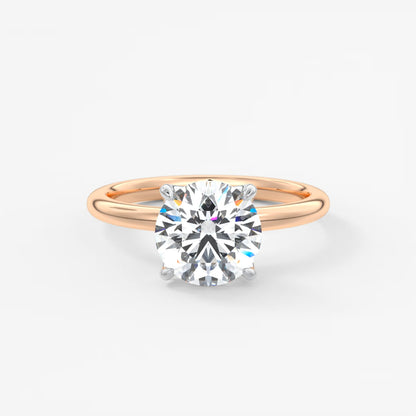 Rose gold ring with a diamond on a white background